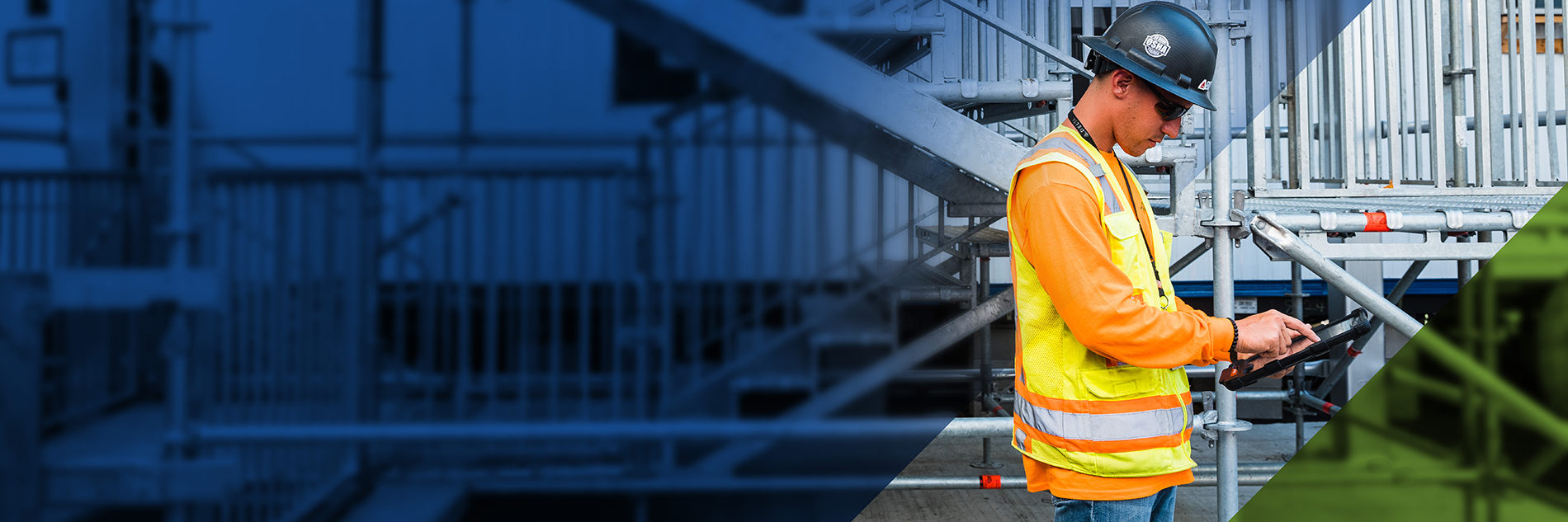 Worker in hardhat using a tablet device