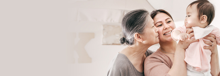 two women holding baby