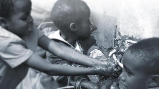 Children washing their hands.