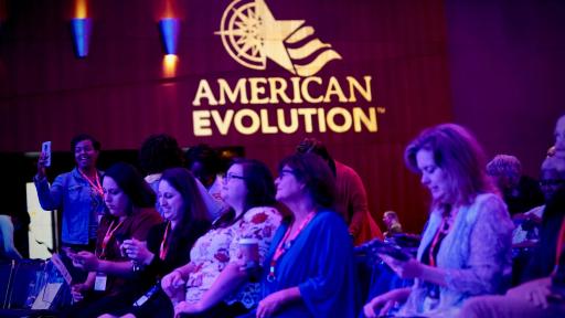 People listening to a presentation in an auditorium