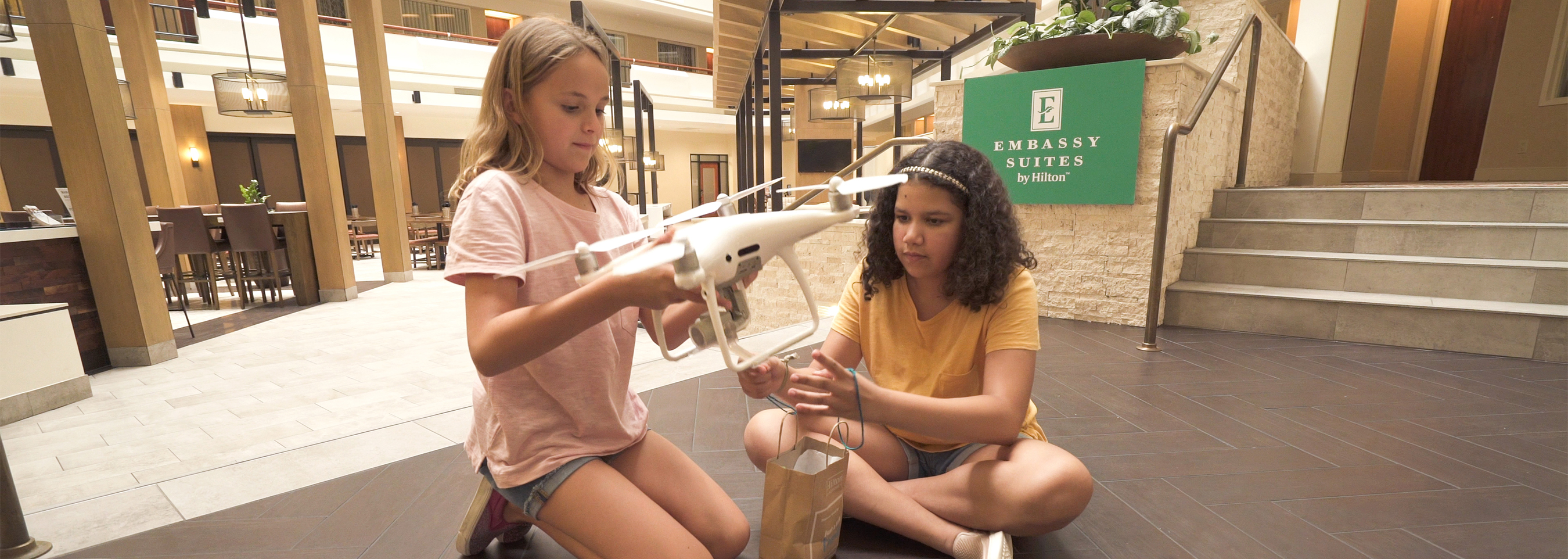 Two girls looking at a drone