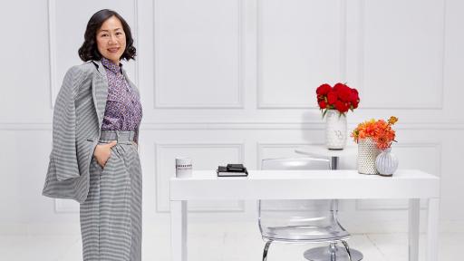 Woman standing beside a desk