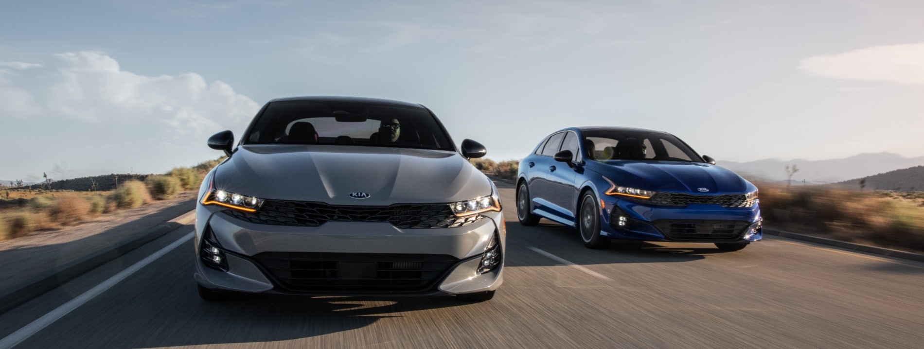 KIA cars driving on a road