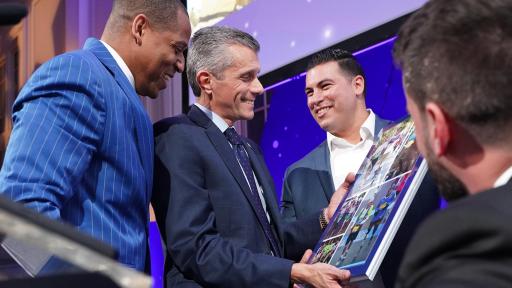 Achilles International Freedom Team members, Cedric King, Stefan LeRoy and Matias Ferreira, present the Volunteer of the Year award to David Cordani, President and CEO of Cigna.