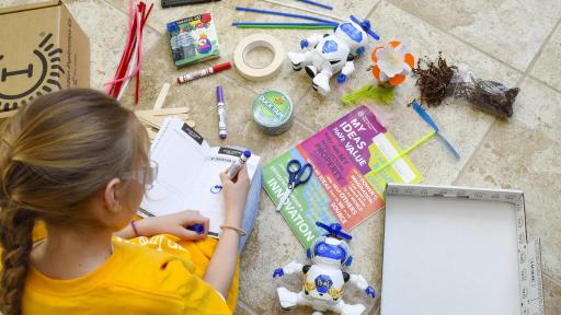 A group of kids holding up booklets