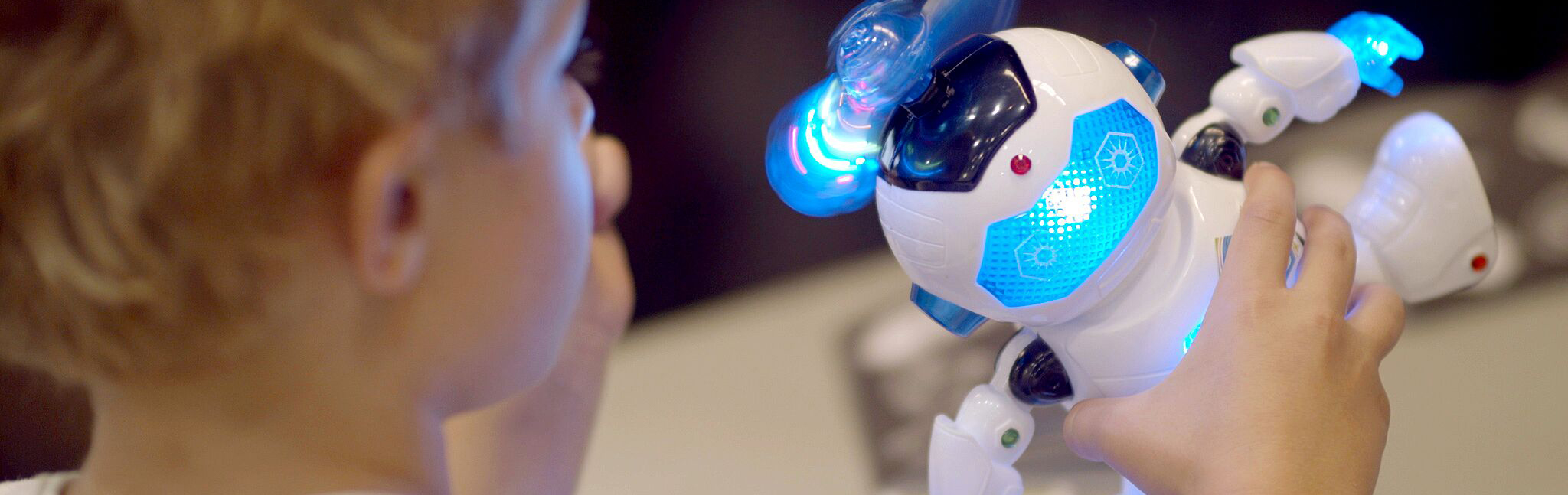 A boy working on a toy robot