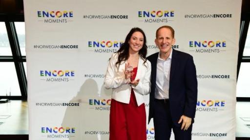 Harry Sommer, incoming president and chief executive officer of Norwegian Cruise Line, presents Leah Egan, Encore Moments winner from Minnesota, with her award at a celebration today in New York City.