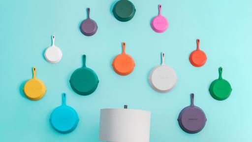 Several skillets hanging on a wall
