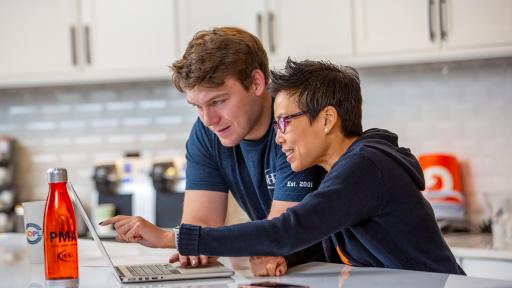 Two people looking at a laptop