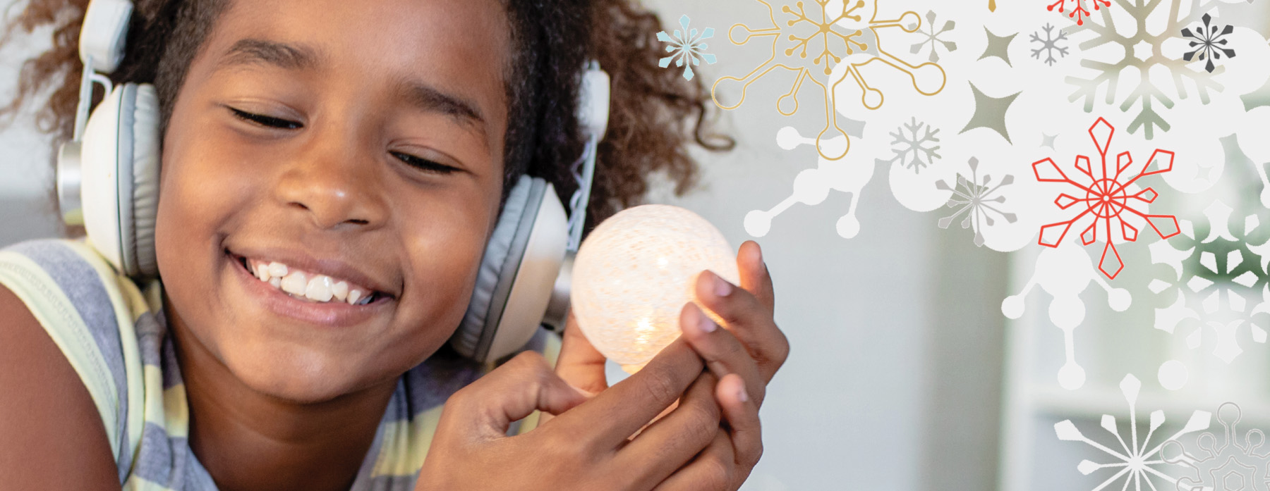 Girl with headphones holding a lightbulb