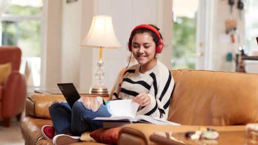 Person on couch studying and listening to music