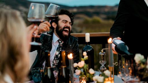 Man raising a glass of wine for a toast