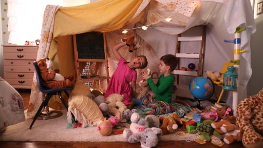 Family in a fort of sheets