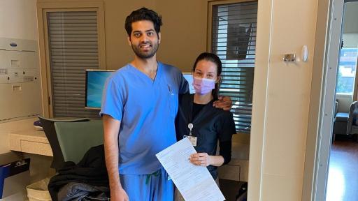 Allison and Noor standing together in medical garb