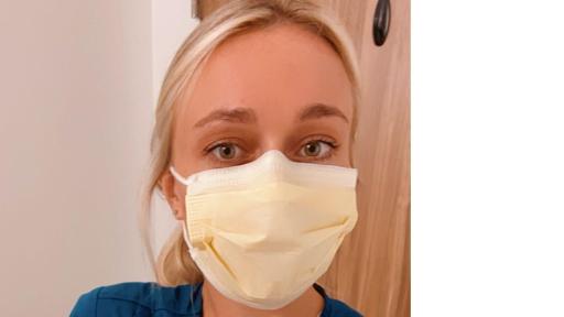 Nurse with a thumbs up in garb