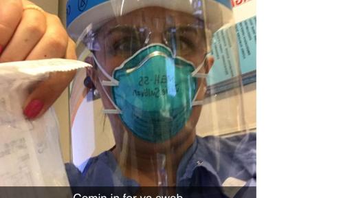 Nurse in garb and face shield