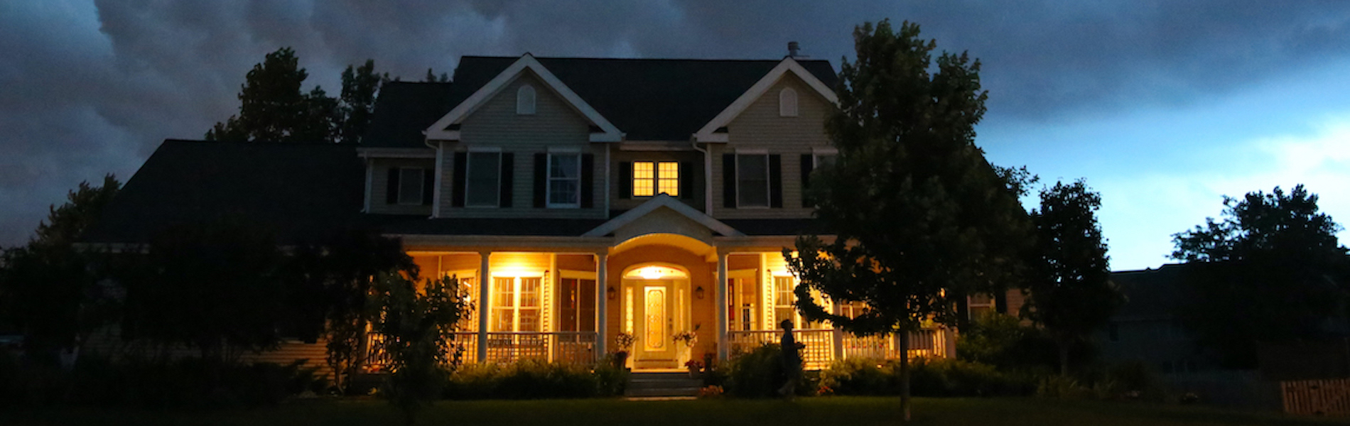 Image of a house at night with lights on