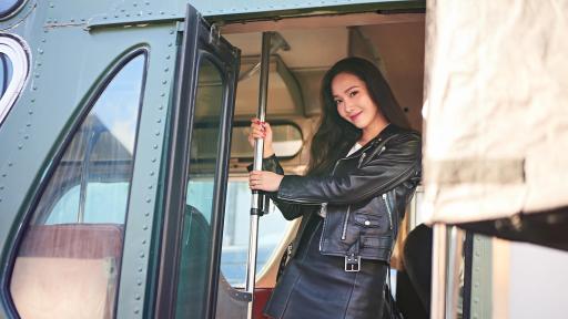 Jessica Jung hanging onto the handrail of a bus