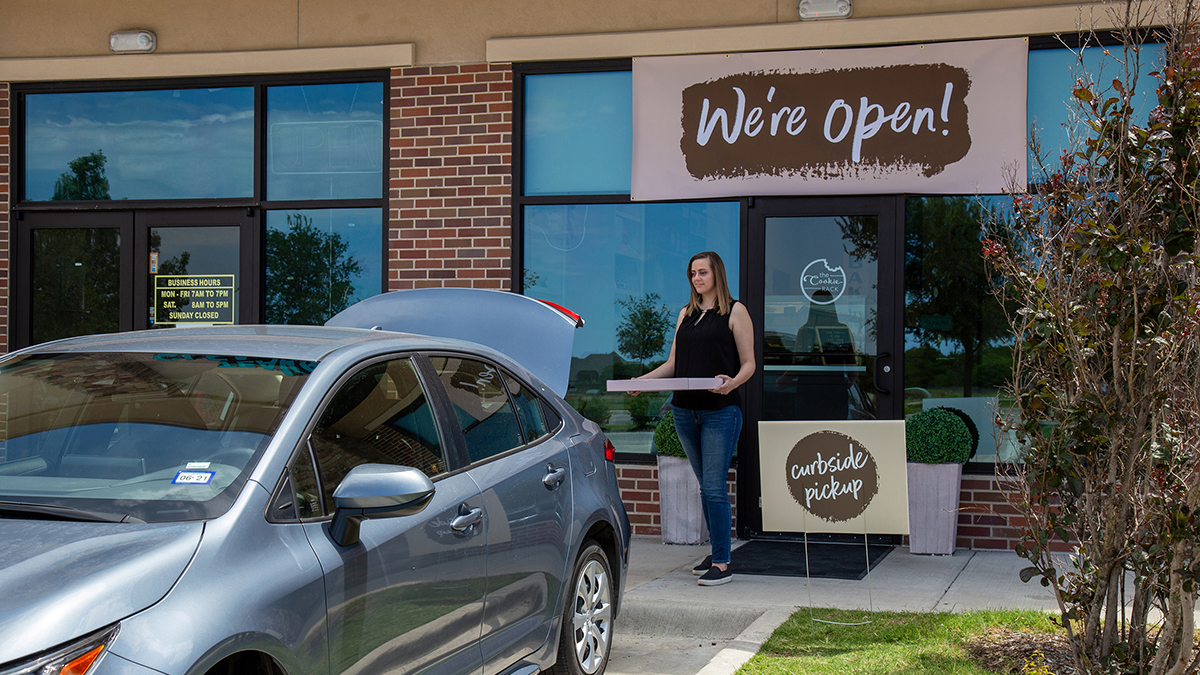 Customer carrying cookies to their car.