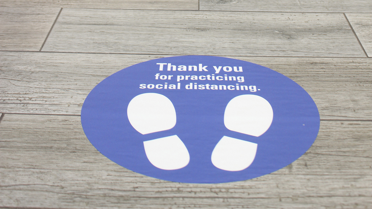 Close up of a social distancing sign