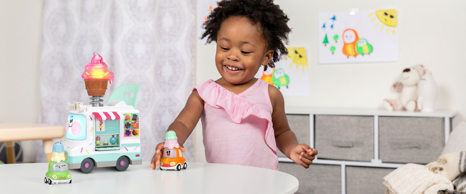 Little girl playing with ice cream truck