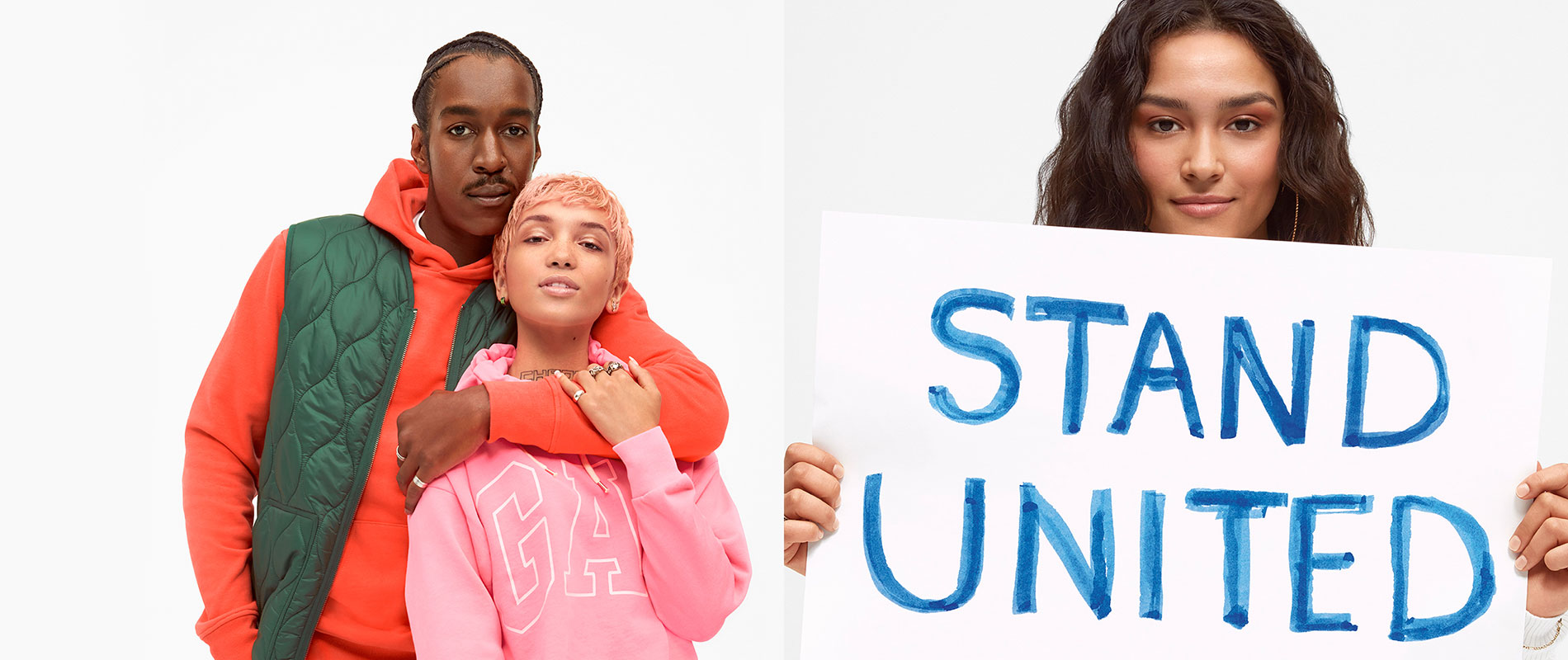 Woman holding sign that says "STAND UNITED"