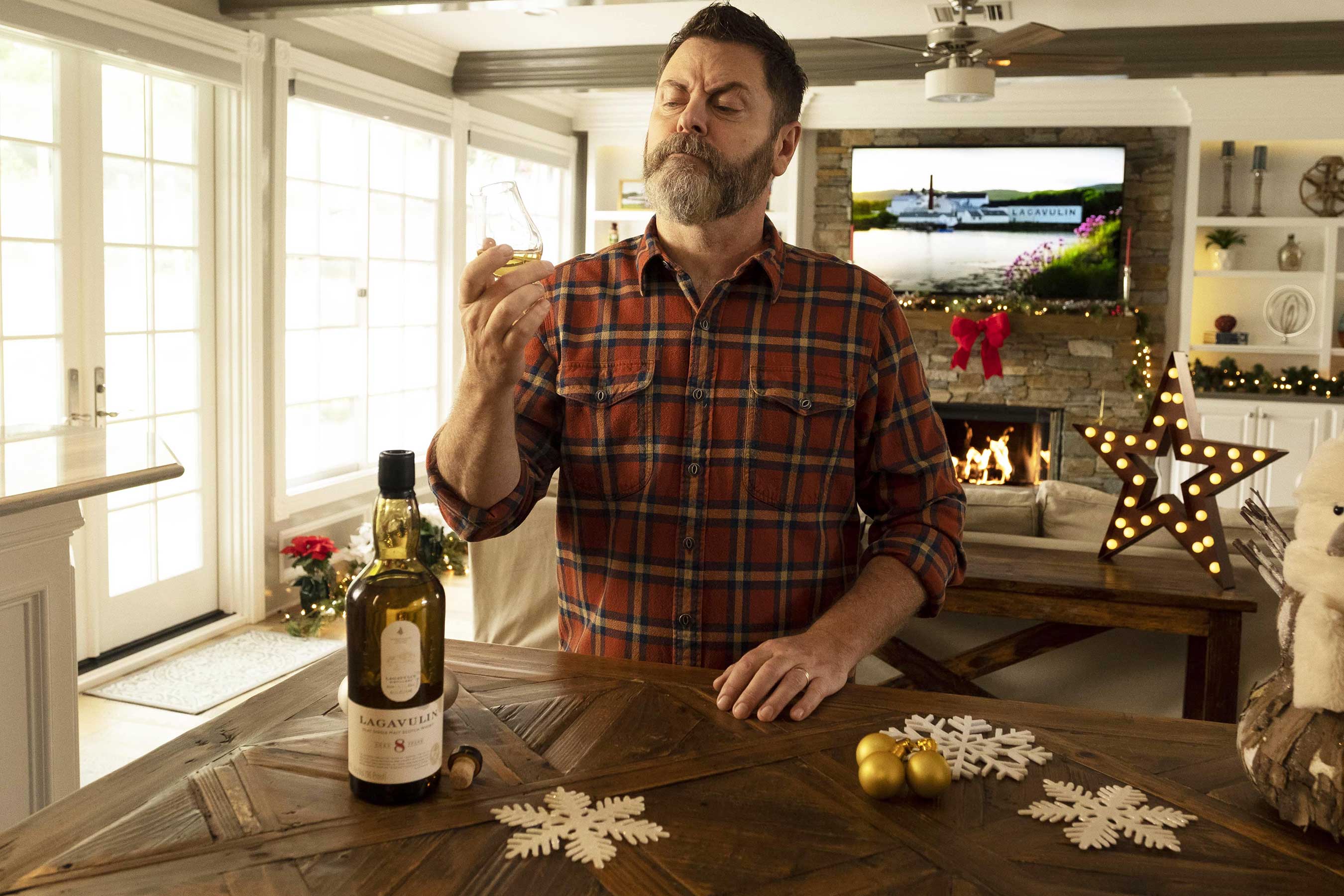 Nick Offerman admires a bottle of Lagavulin Single Malt Scotch Whisky