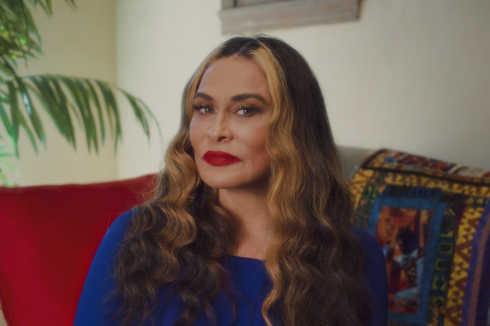 Photo of Miss Tina sitting on a red couch