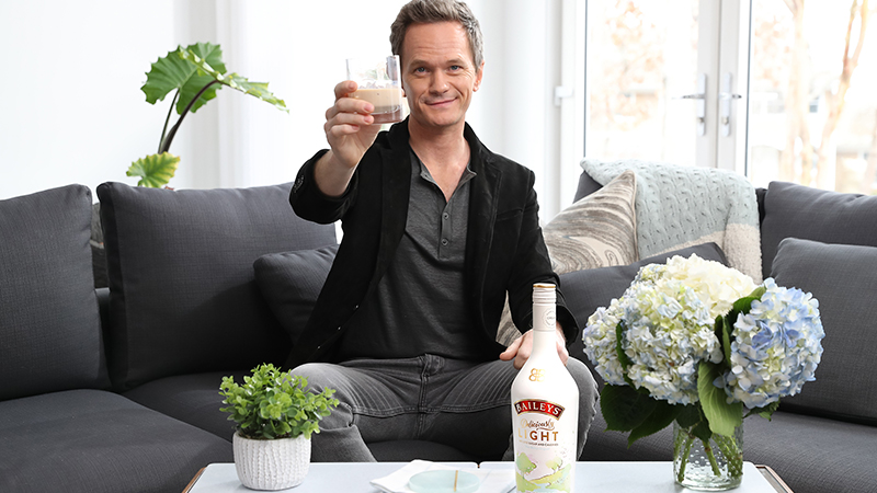 Neil Patrick Harris holding up a drink