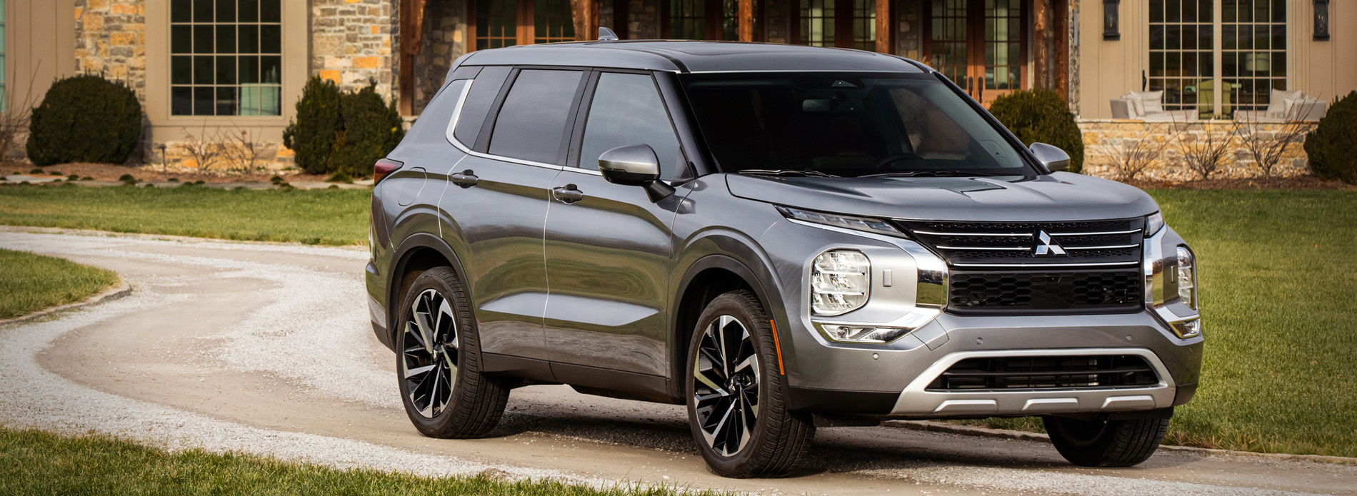 2022 Mitsubishi in front on a large home