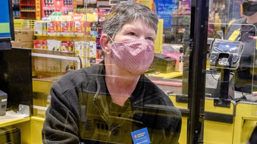 No Frills cashier serves customer