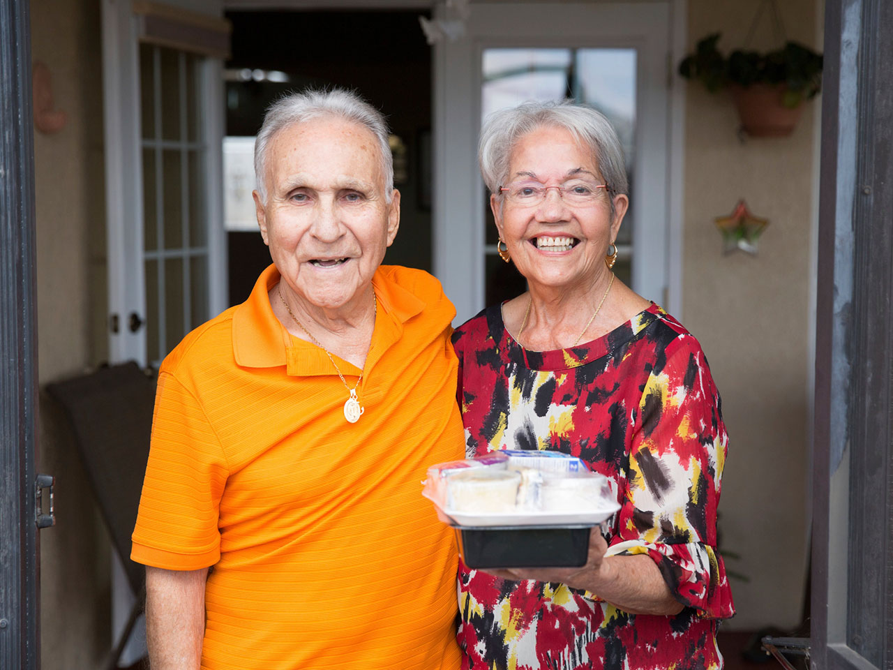 A senior couple, clients of Meals on Wheels America, after receiving their meal.