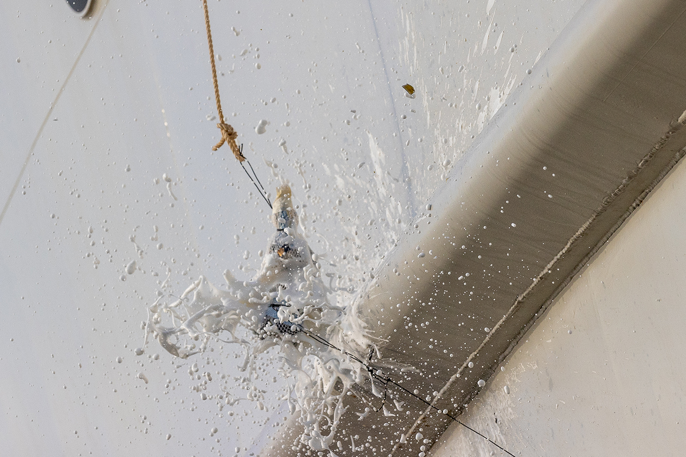 A bottle smashes against Silver Origin’s hull during the naming ceremony
