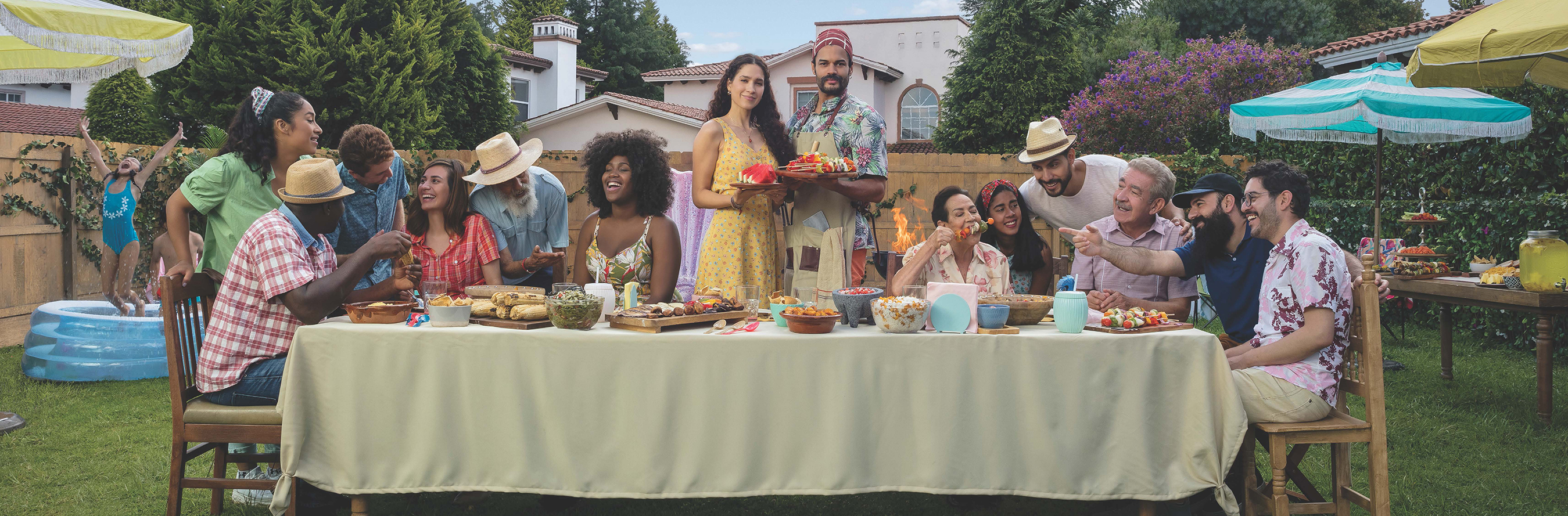 People sat around a table at a barbeque.