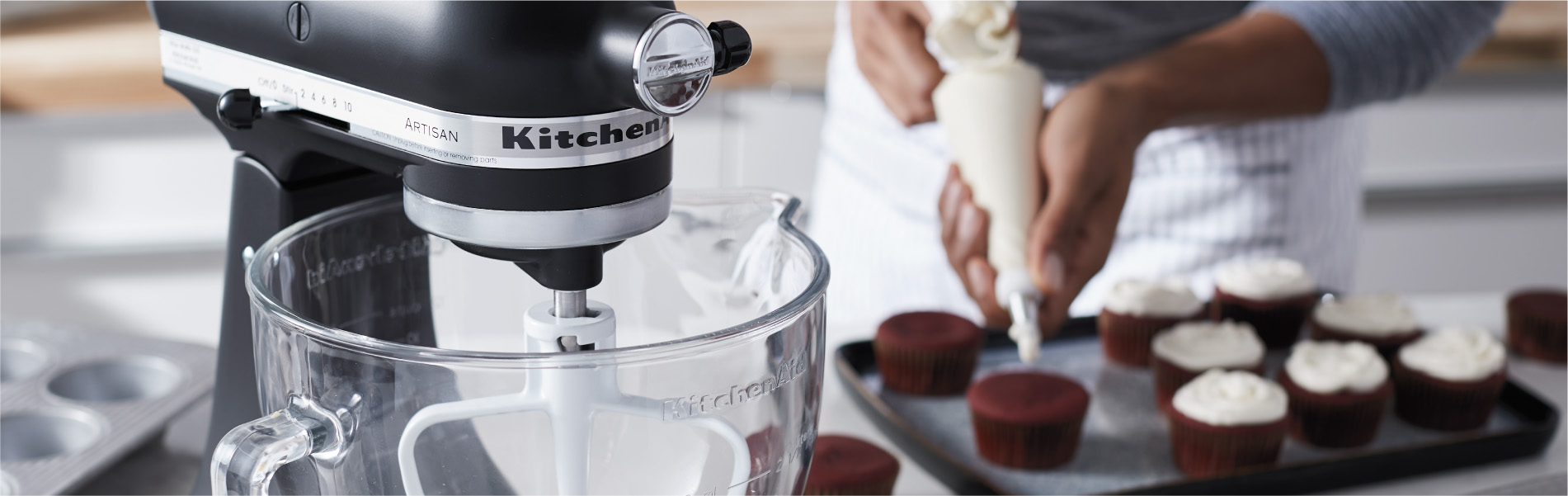 baker frosting cupcakes