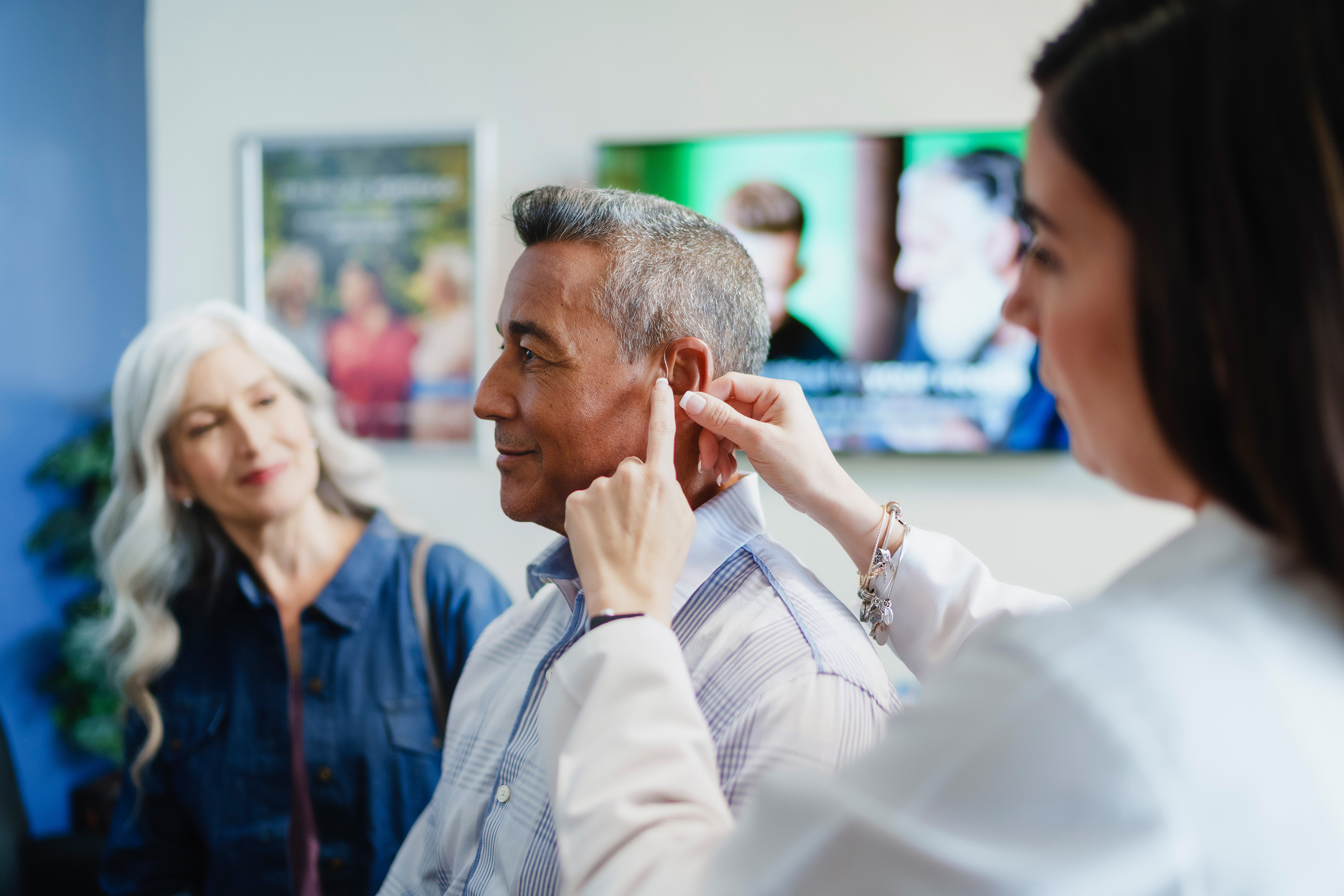 Patient being fitted with Beltone hearing aid