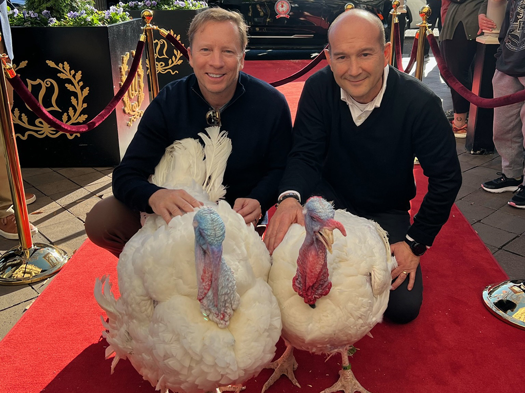 NTF Chairman Steve Lykken and Jose Rojas from Jennie-O Turkey Store escort Liberty and Bell down the red carpet at the Willard InterContinental.