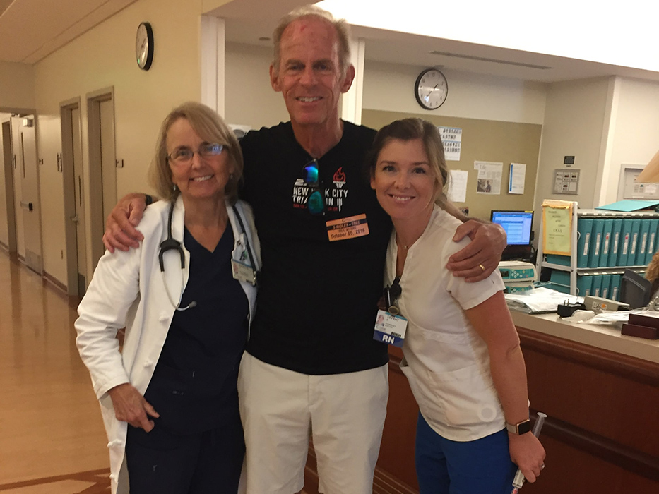 Neil taking a picture with nurses