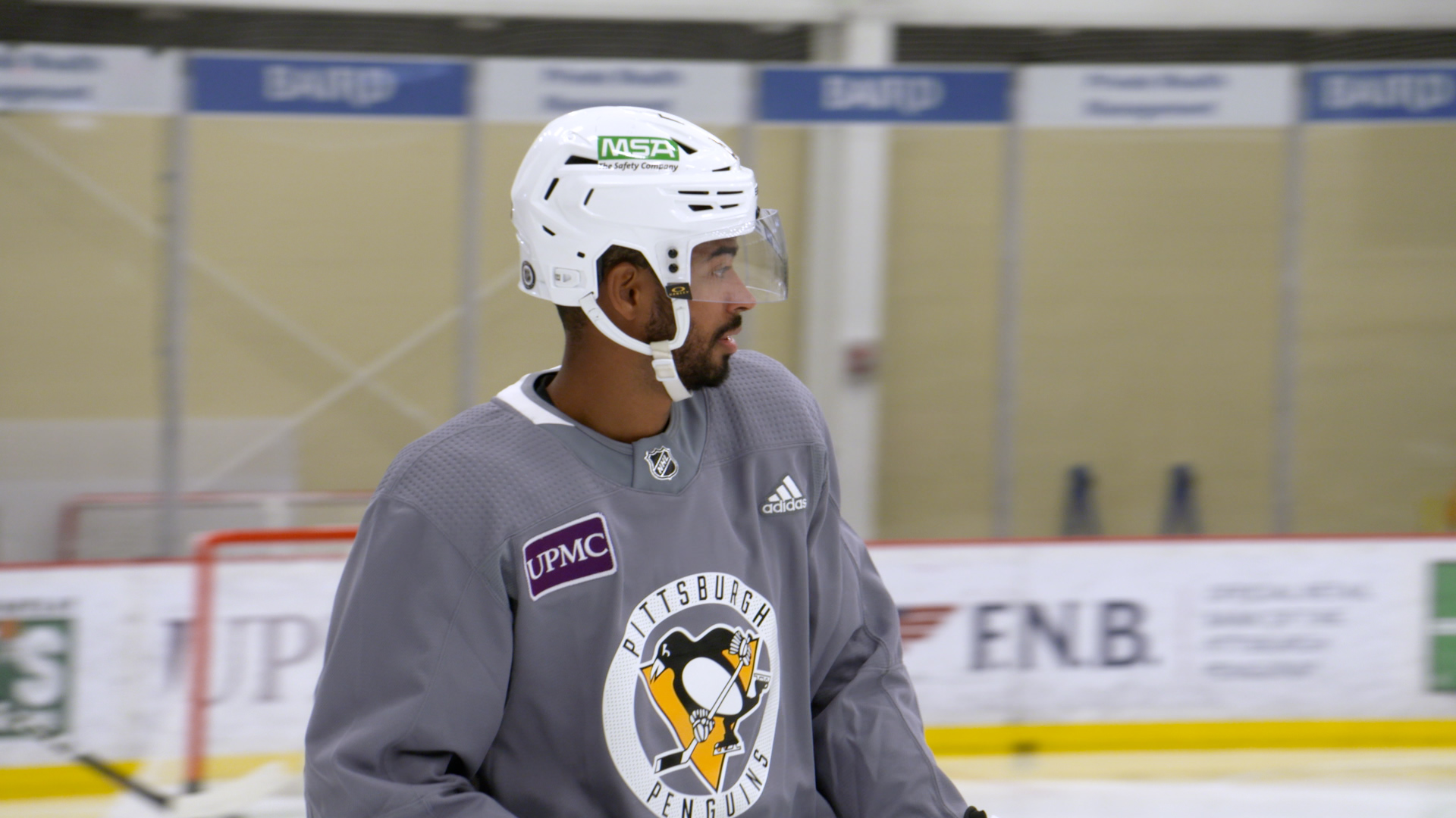 A member of the Pittsburgh Penguins wearing one of the away game helmets during an open skate.
