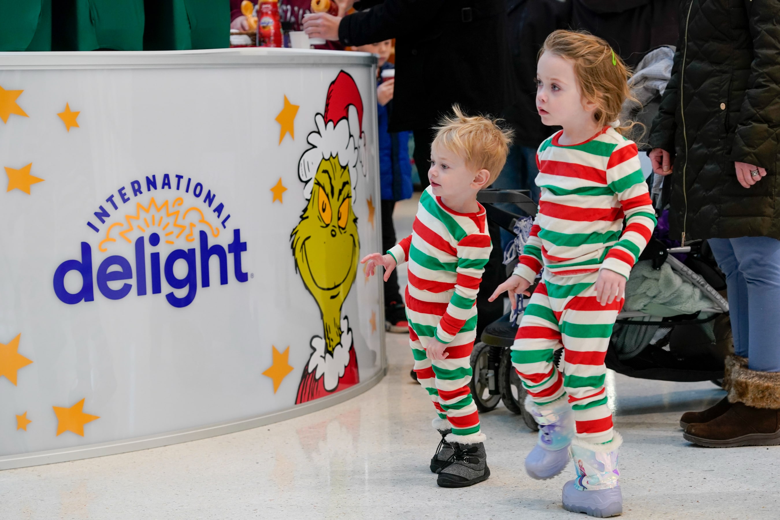 Young fans look for the Grinch, who was at Mall of America on Thursday, Dec. 8, 2022, serving up free coffee with International Delight Grinch Peppermint Mocha creamer.