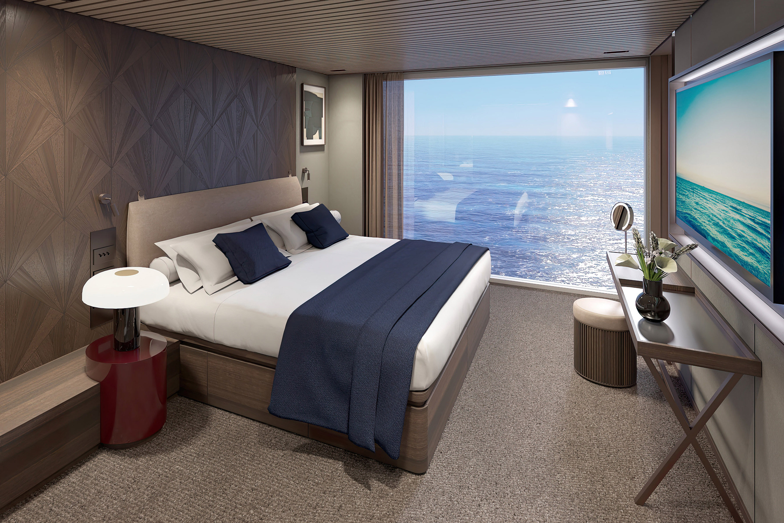 The master bedroom on board Norwegian Aqua’s three-bedroom Duplex Haven Suite boasts floor-to-ceiling windows, offering unparalleled views from the comfort of this luxury stateroom.