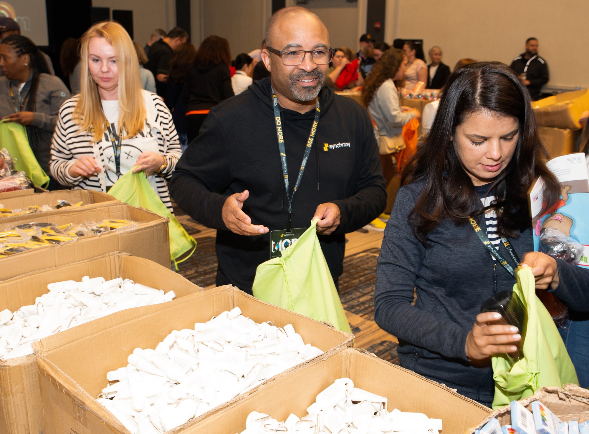Synchrony employees participated in a volunteer event where they assembled 10,000 activity kits that included financial education resources to support Chicago, IL elementary and college students. This is part of the company’s Global Diversity Experience where employees engaged in panel discussions, workshops and community service initiatives. (Photo credit: TheWrightVision for Synchrony)