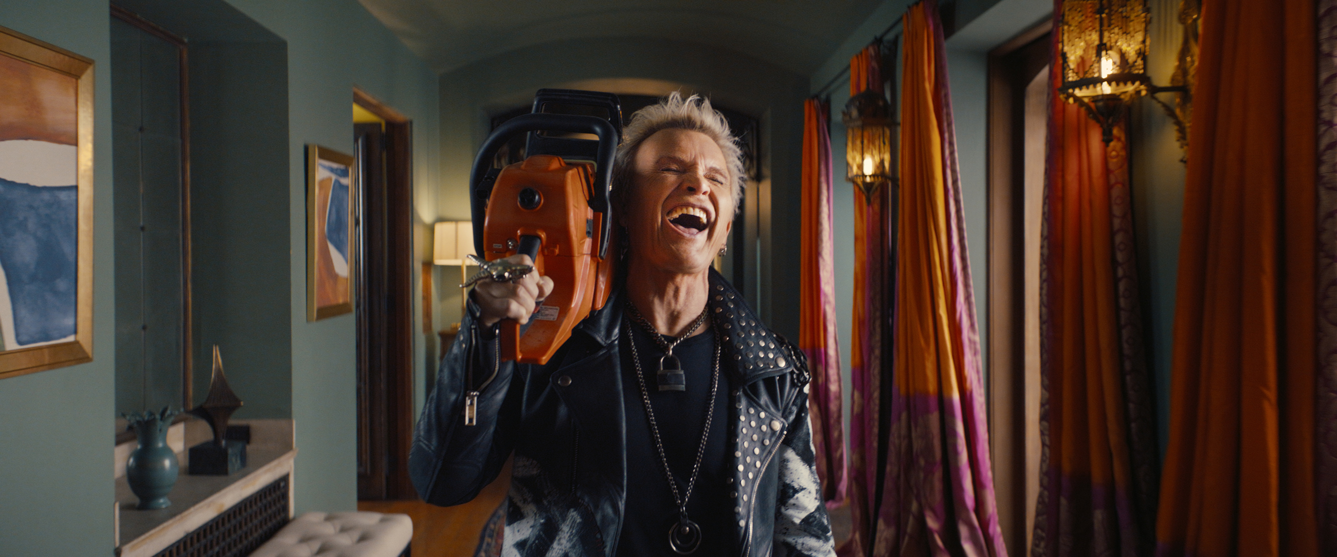 Chainsaw wielding punk rock icon Billy Idol reminds viewers he has trashed hotel rooms in 43 countries. Courtesy: Workday