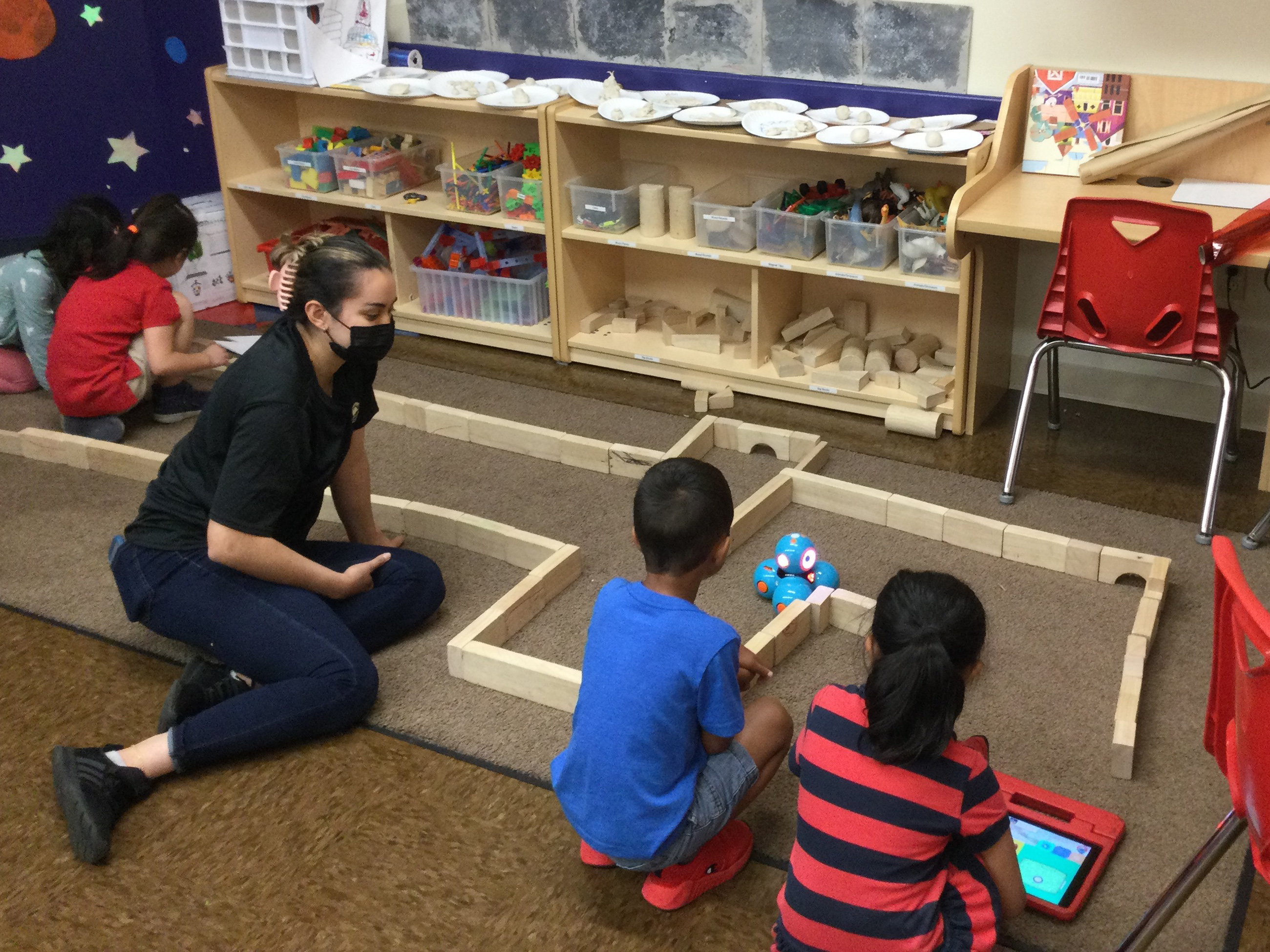 Students at the Primrose Schools Summer Adventure Club engage with an interactive robot named Dash through coding and special missions.