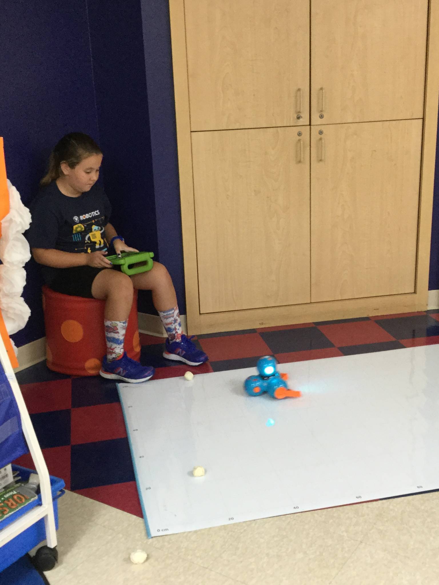 Children further STEM-based learning by interacting with a programmable robot named Dash as part of the two-week Primrose Schools robotics curriculum.
