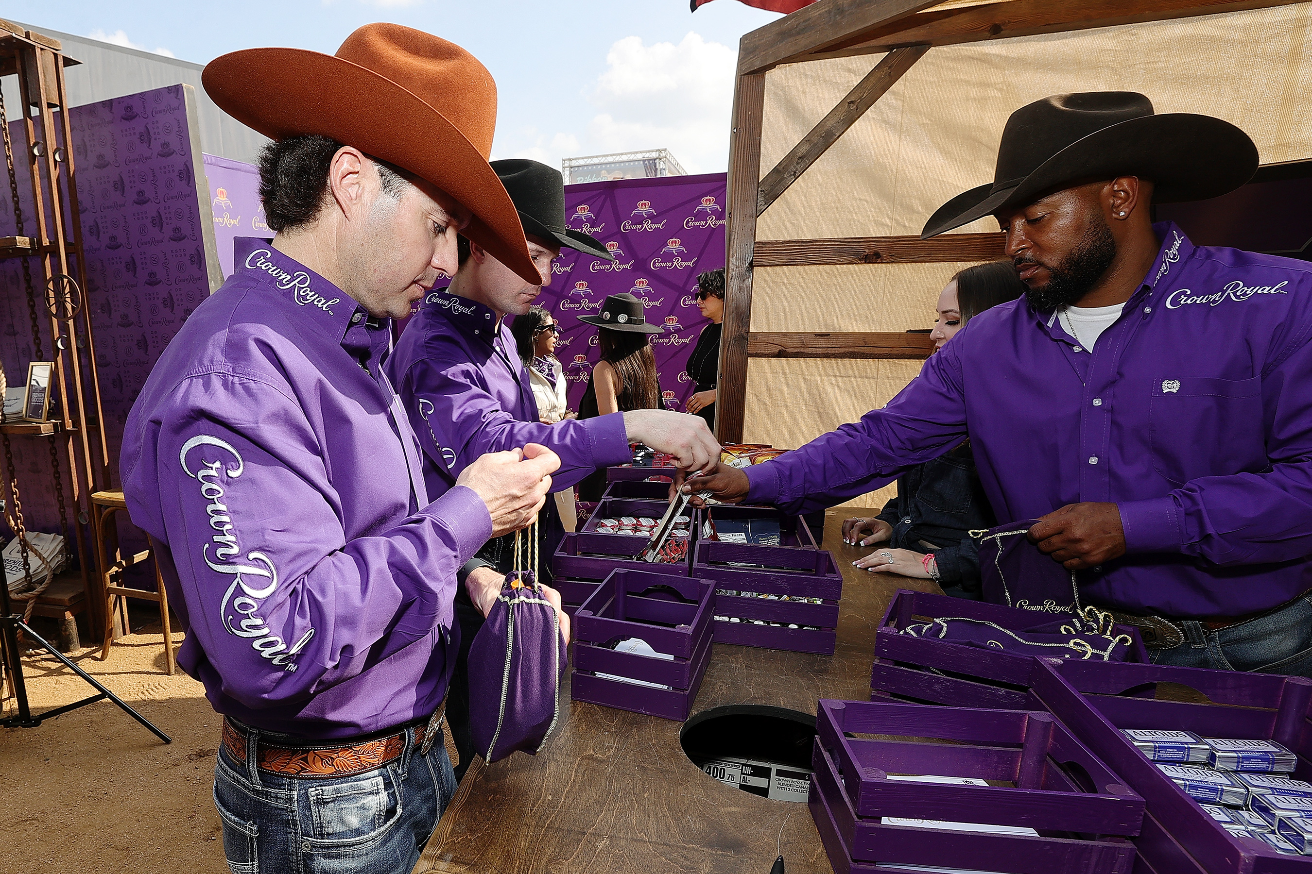 Crown Royal Royal Riders Wesley Silcox, Garrett Smith and Tory Johnson participate in the Purple Bag Project at the Crown Royal Ranch at the Houston Rodeo at NRG Park in Houston, Texas. (Photo by Bob Levey/Getty Images for Crown Royal)