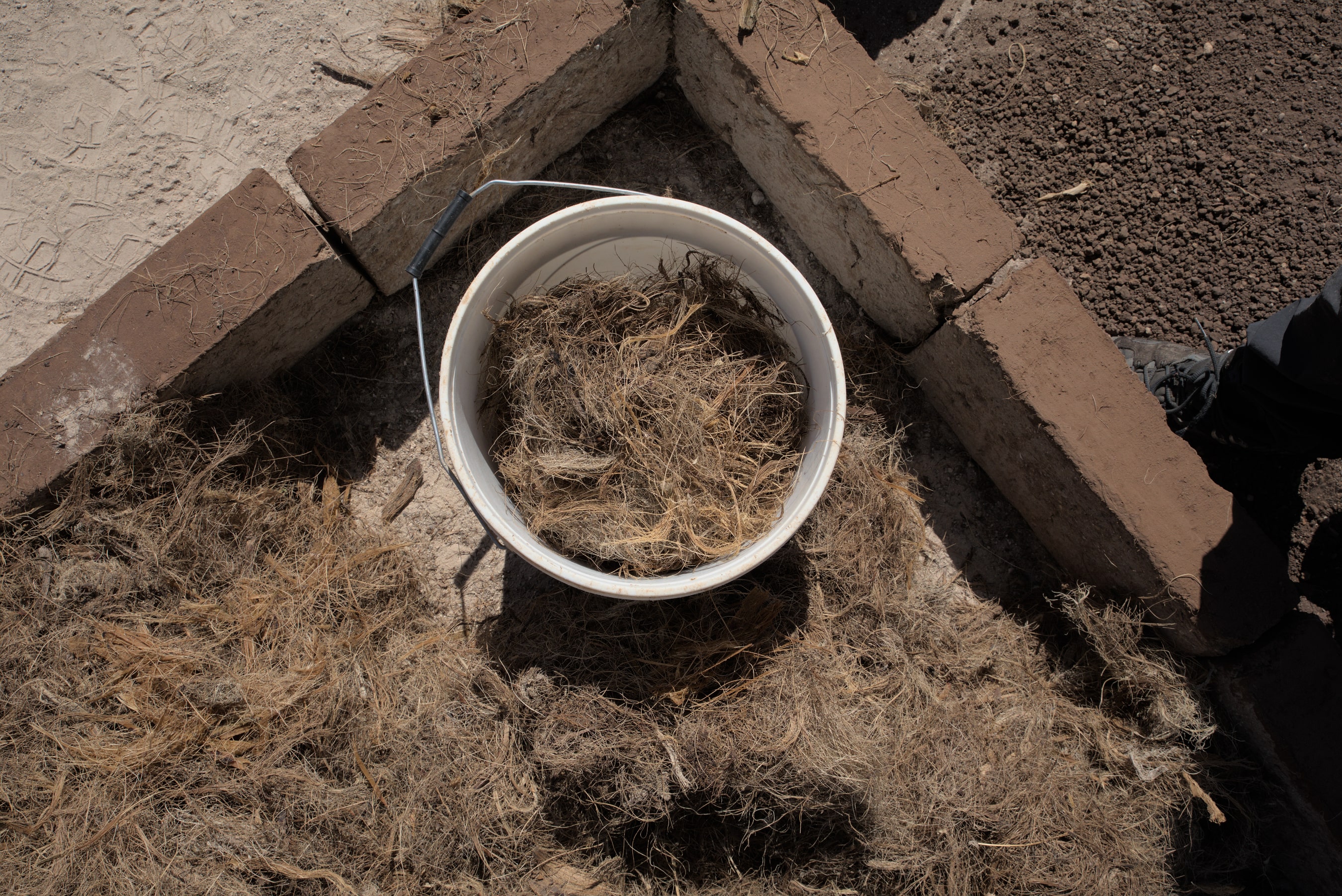 The crushed agave fibers, or bagazo, from the distillation of Astral Tequila are upcycled and combined with other raw materials to create adobe bricks, which are then used to build homes in Mexico.