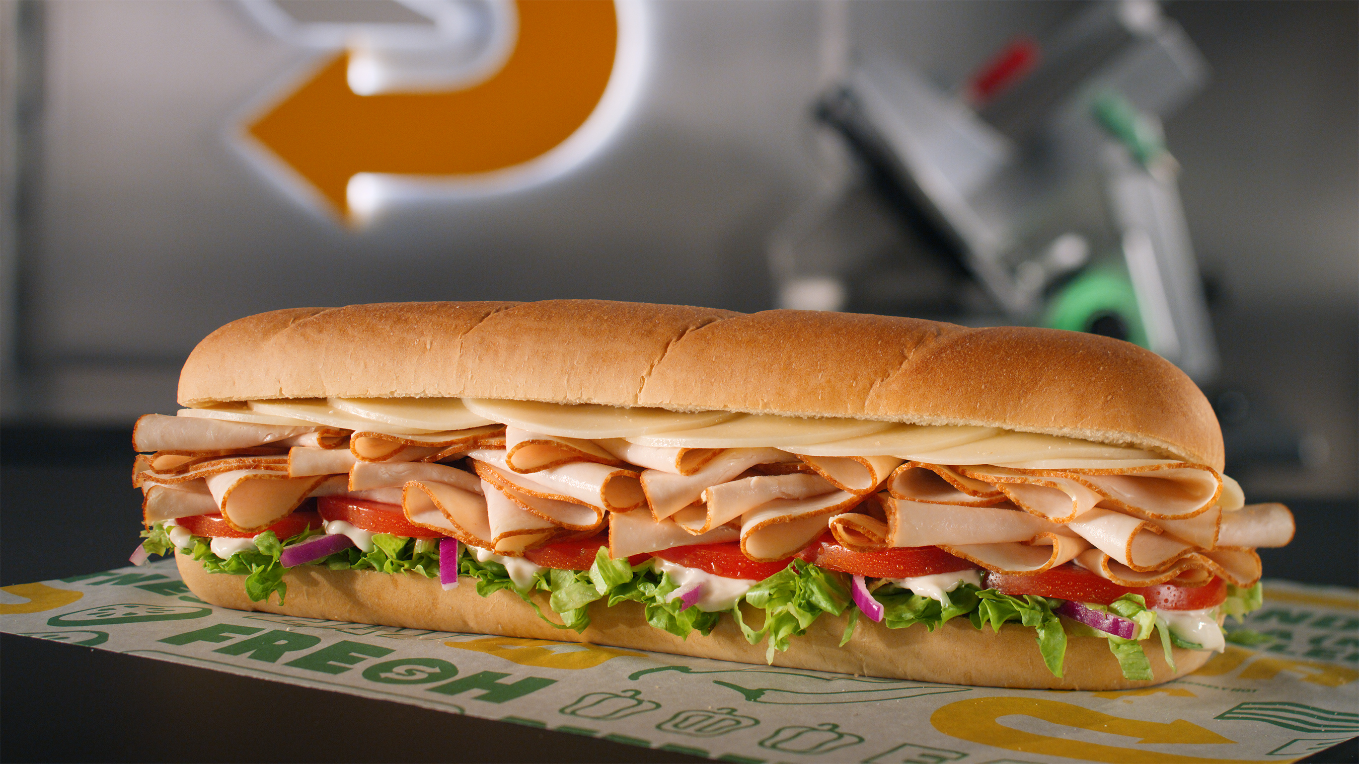 The Titan Turkey (#15) features 33% more meat than traditional subs, with freshly sliced turkey and double provolone cheese on Artisan Italian bread, topped with lettuce, tomatoes, and red onion, and finished with mayonnaise.