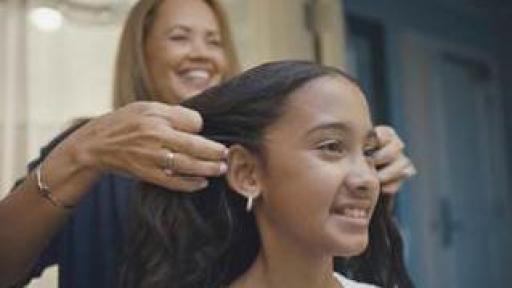 Mother braiding daughter's hair