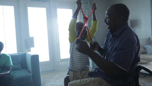Father in a wheel chair playing with his son
